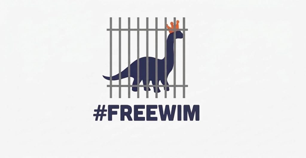 Een dinosaurus met een kroontje achter tralies, met de hashtag #FREEWIM.